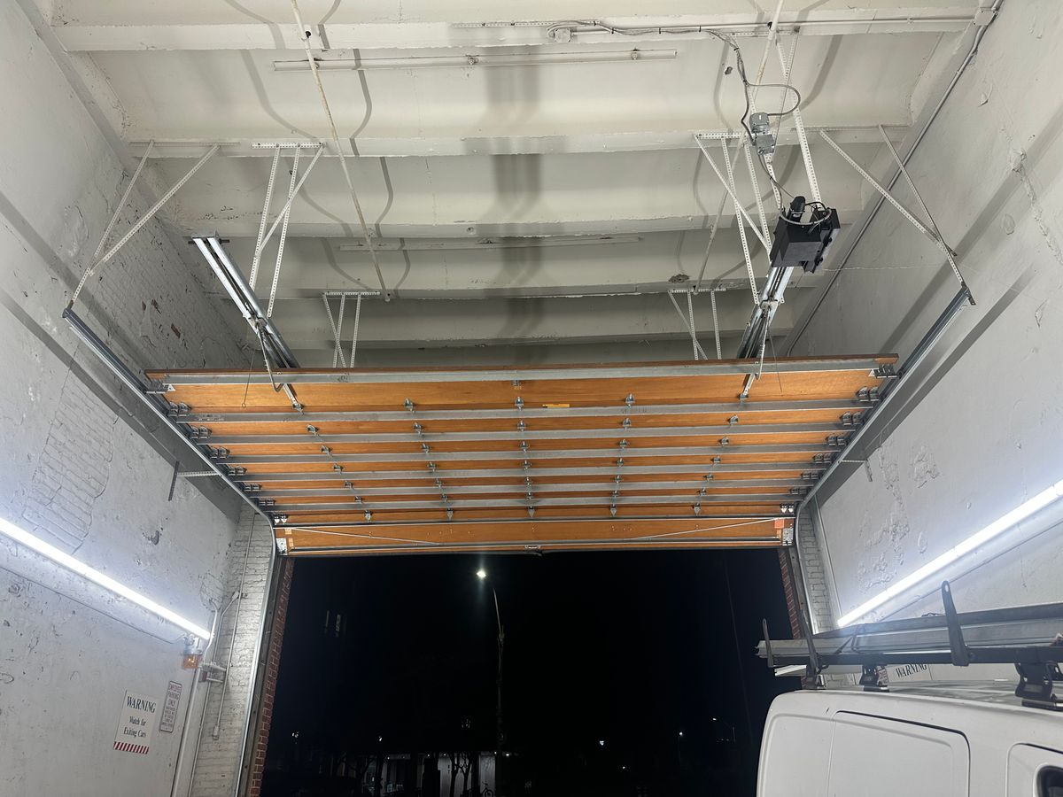 Commercial overhead door interior view showing track and opener system