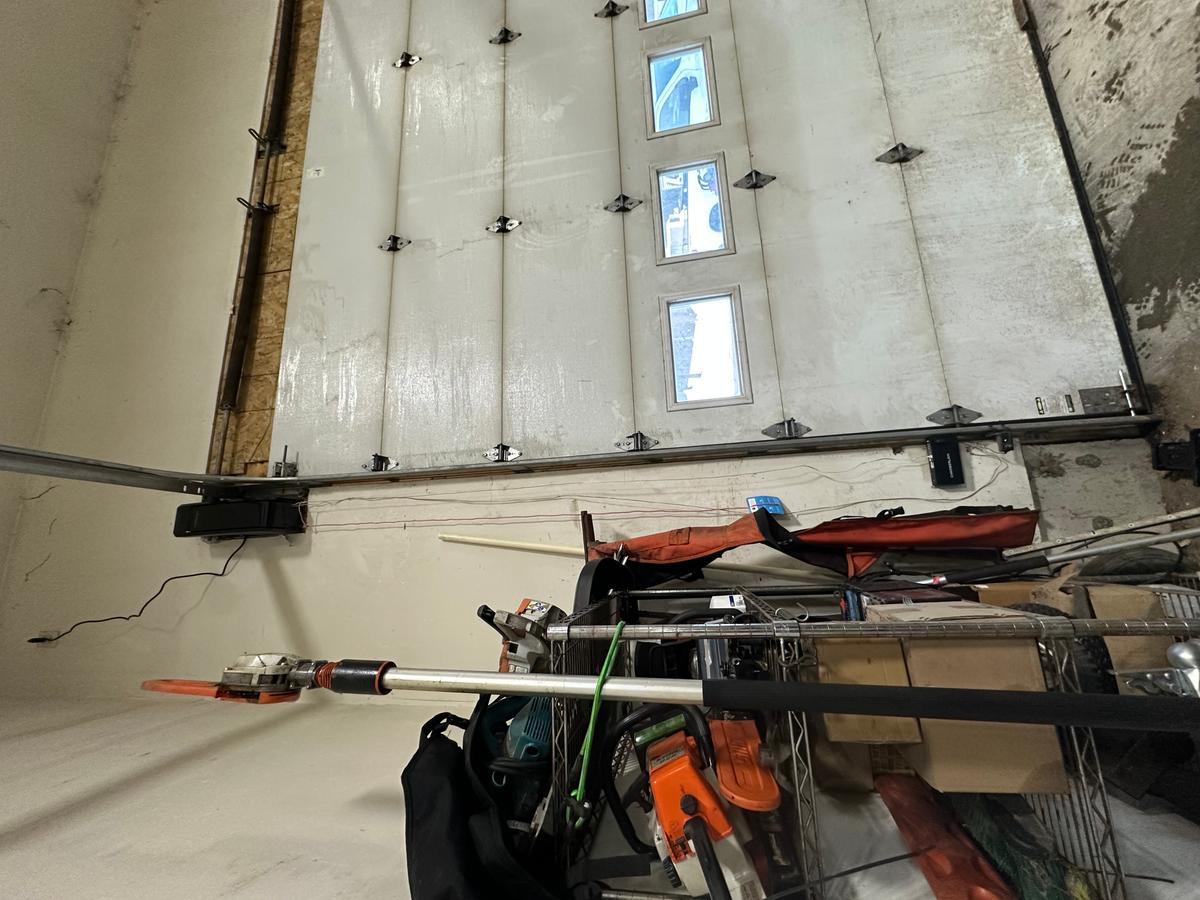 Alternate interior angle of commercial sectional door with vertical windows and opener rail